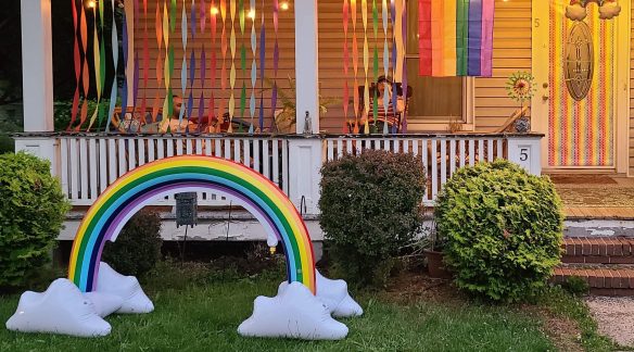 Image of a inflatable rainbow at night with a couple in the background.