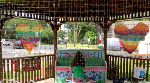 A girl sitting in a gazebo.