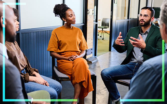 Blog header image of four people discussing how to invest in their employer brand.