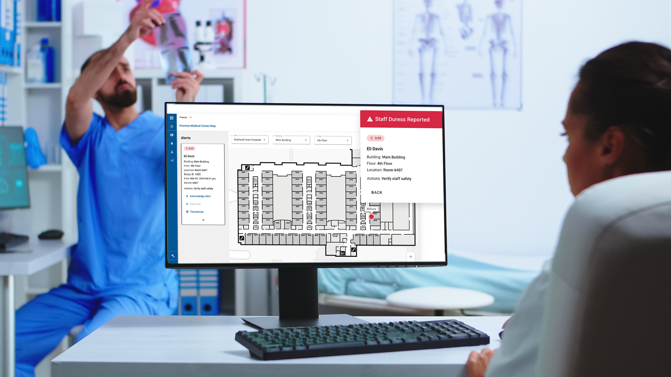 Nurse looking at a hospital map on a desktop computer.